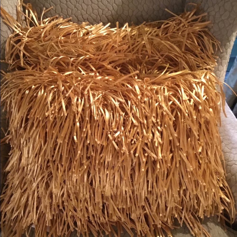 Two yellow pillows with satin fringe